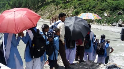 student crossing river by trolley.