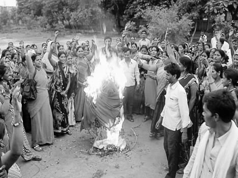 Sarees blow by workers performing