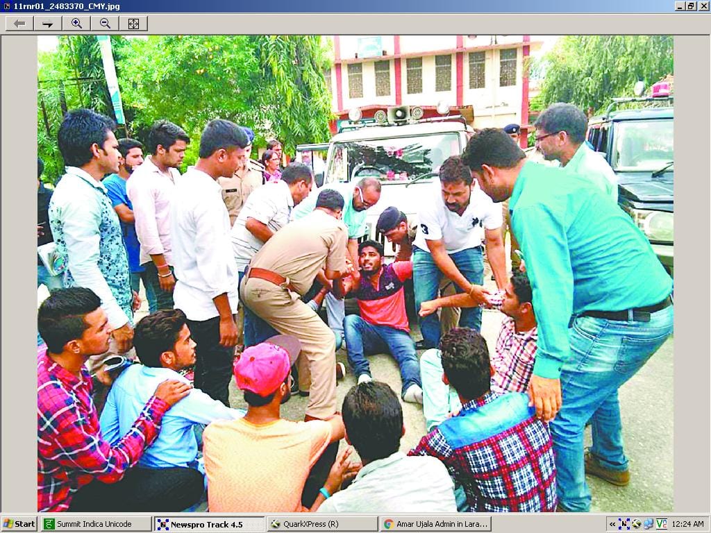 Lying next to a police car ABVP worker