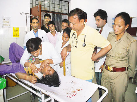 Young woman doctor at the district hospital to treat the wounded.