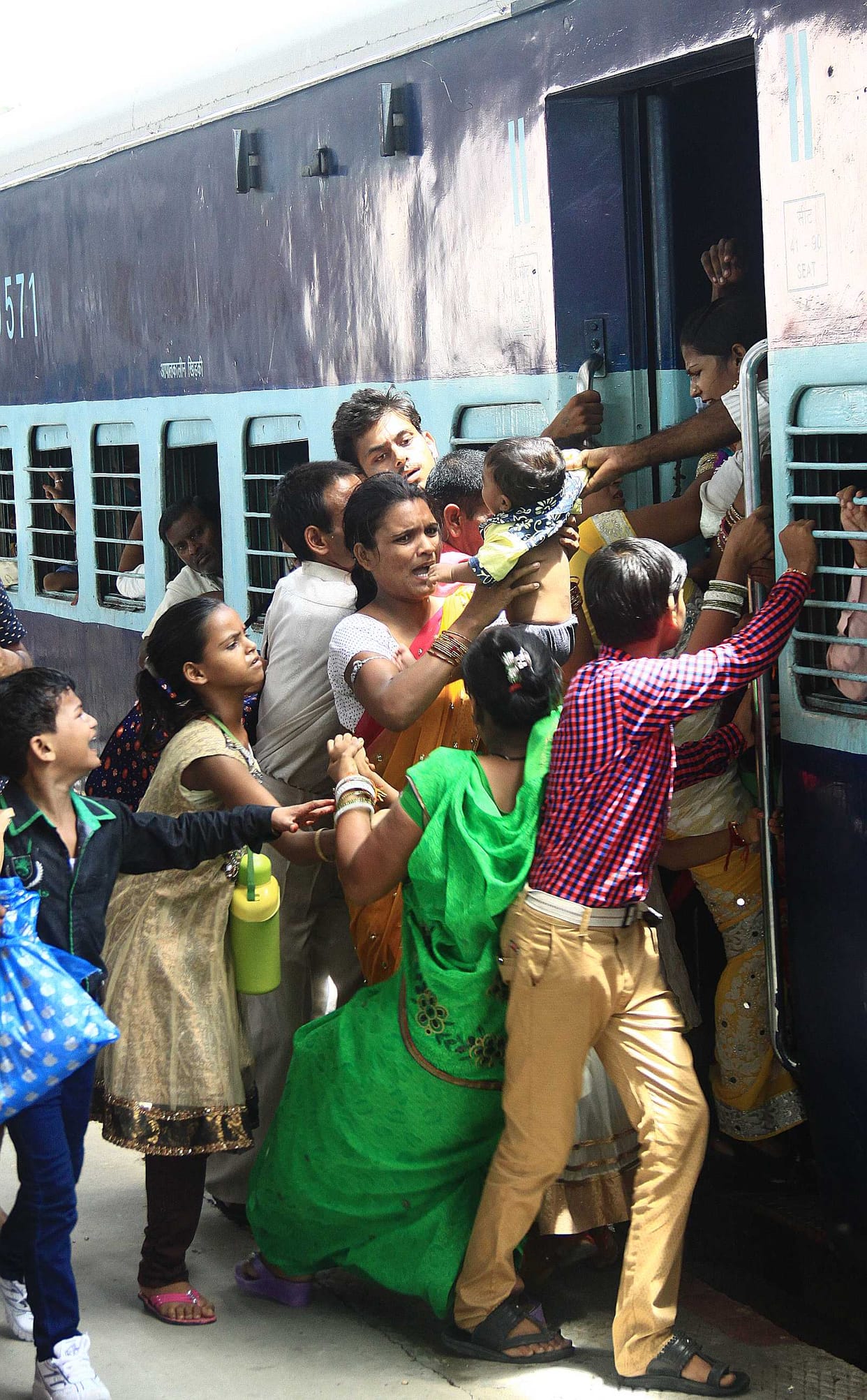 Child fell from her mother's lap Train coming down the left