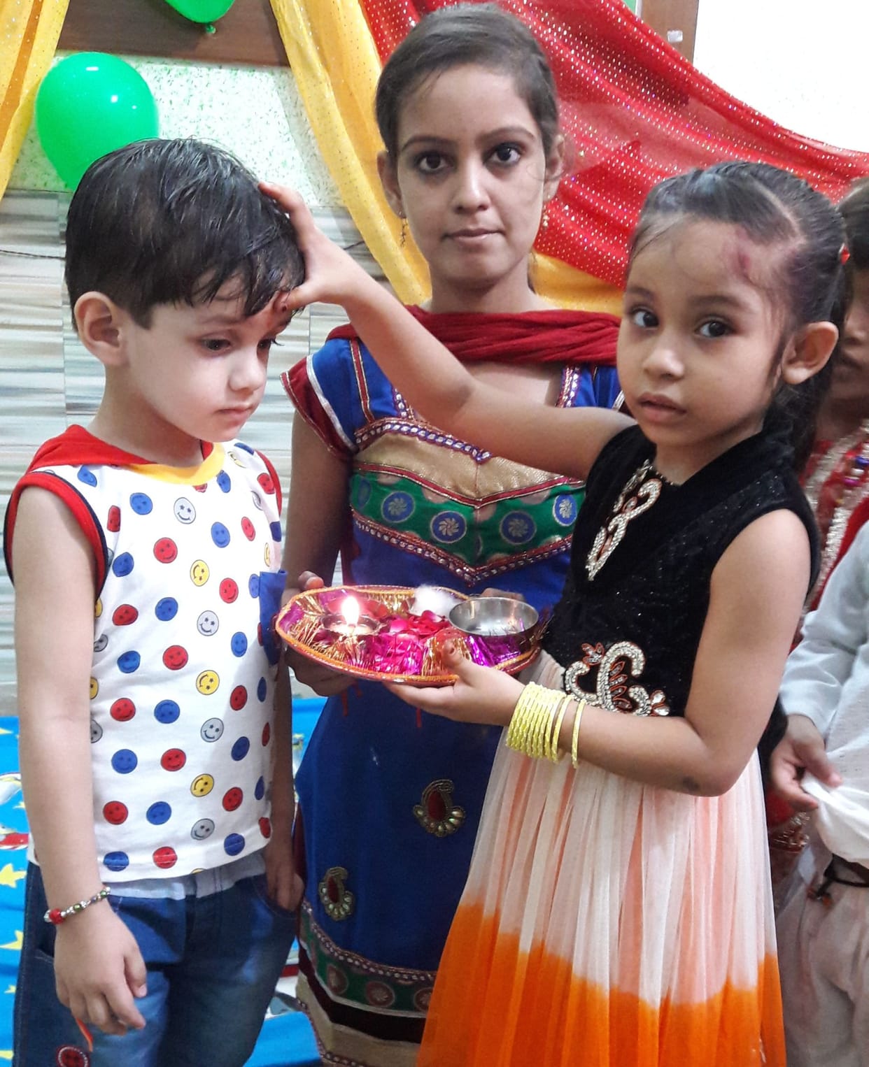Binding thread in the hand of the brothers and brighten tilak on the forehead 