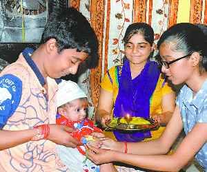 Tied a rakhi on the wrist of brothers