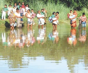 school children going to school in flood