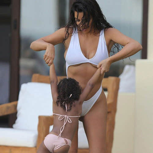 kim kardashian enjoying with her daughter in a swimming pool