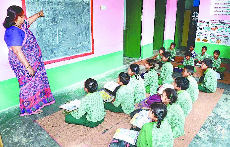 Children of five classes sit together