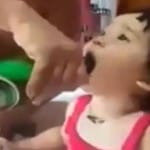 father feeding beer to baby