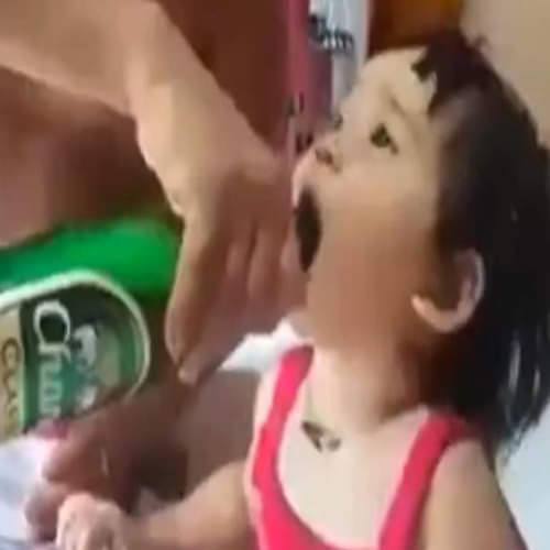 father feeding beer to baby