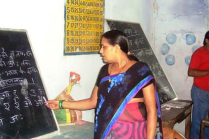 Students of two classes learning on same black board at same time in Bihar