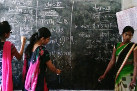 Students of two classes learning on same black board at same time in Bihar
