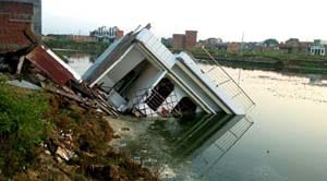 Homes silt , mud pile , damaged windows , doors