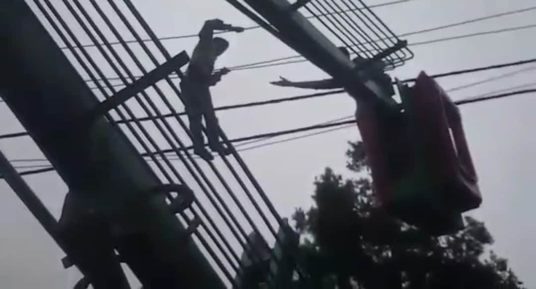 Mentally disturbed young man climb on electricity pole