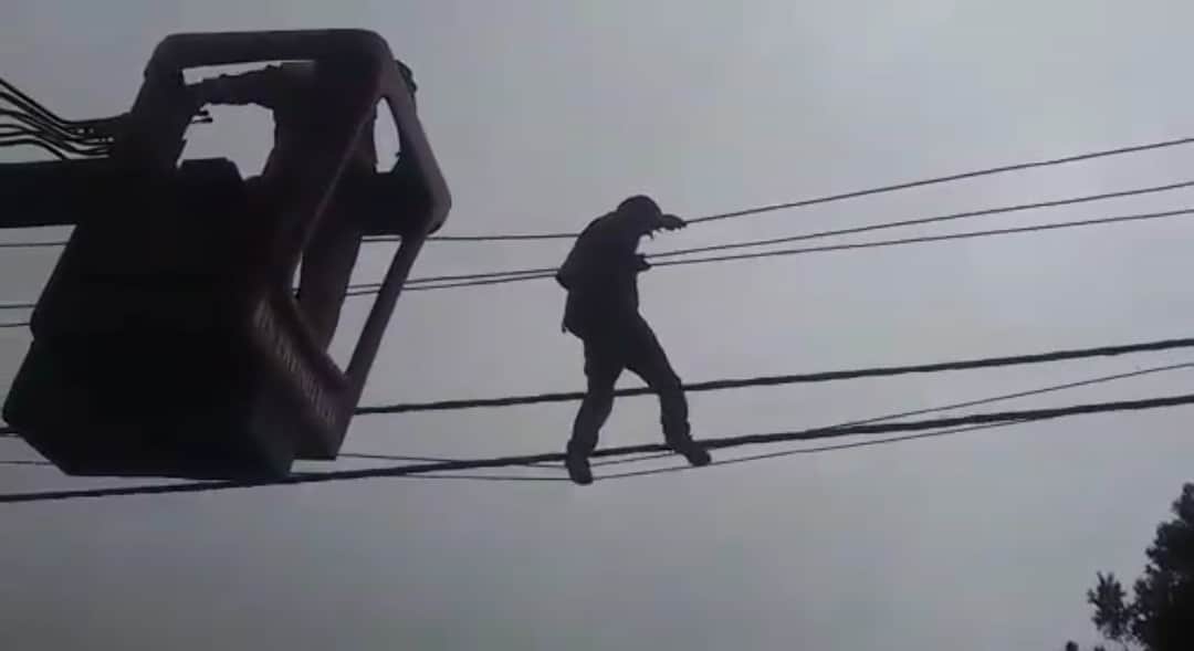 Mentally disturbed young man climb on electricity pole