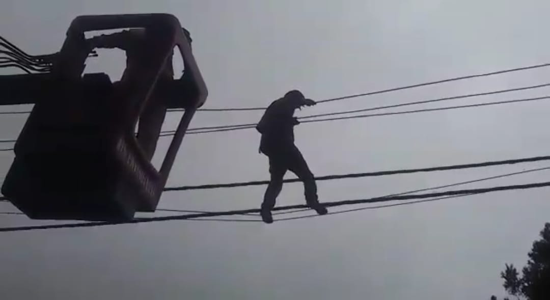 Mentally disturbed young man climb on electricity pole
