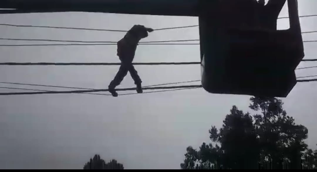 Mentally disturbed young man climb on electricity pole
