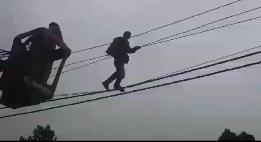 Mentally disturbed young man climb on electricity pole