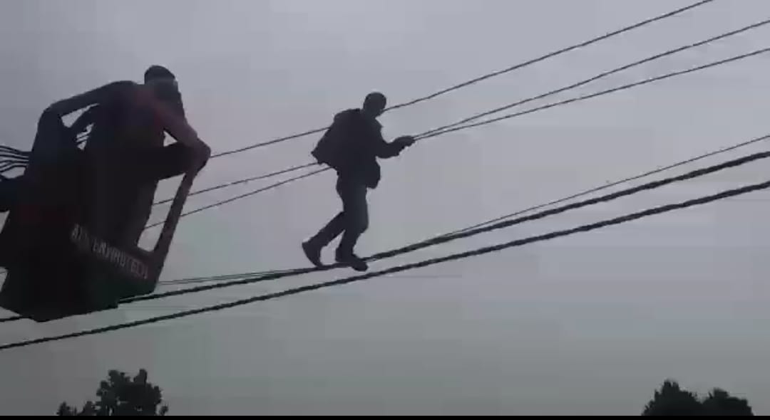 Mentally disturbed young man climb on electricity pole