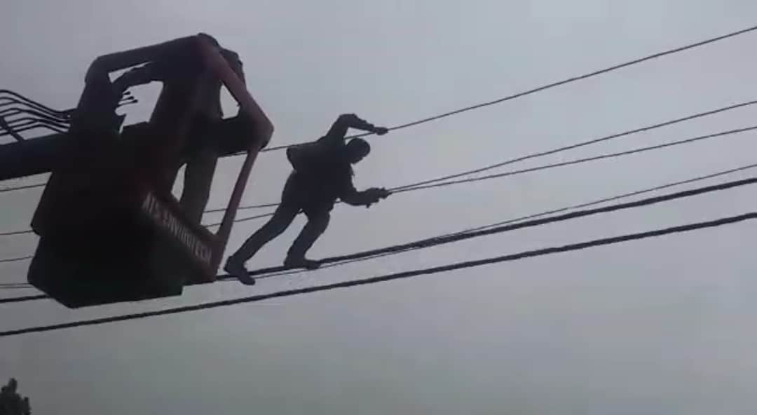 Mentally disturbed young man climb on electricity pole