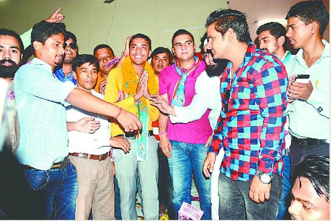 Student President joyful between opposing candidates