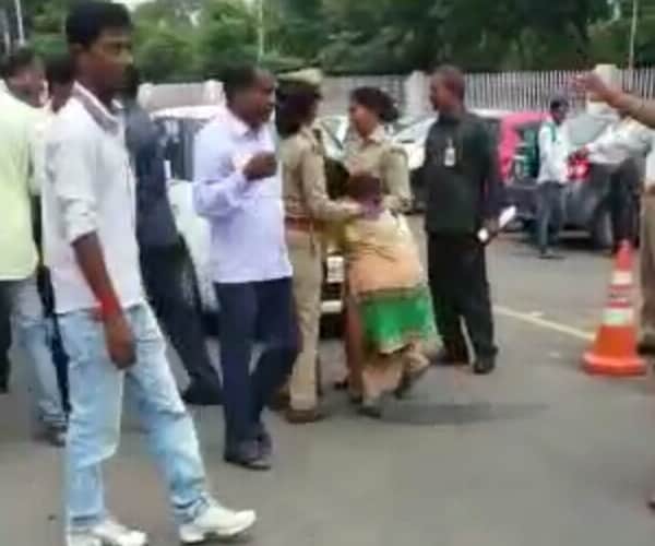 Police beats a woman in front of Chief minister's house.