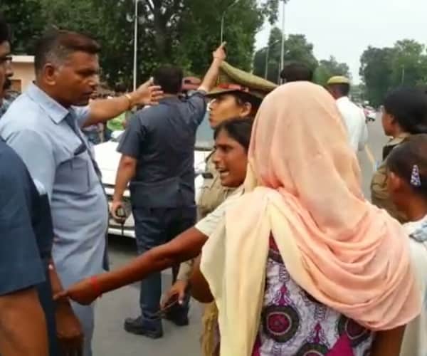 Police beats a woman in front of Chief minister's house.