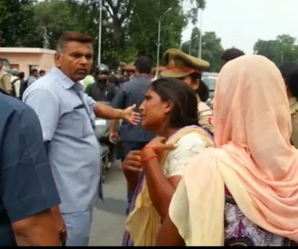 Police beats a woman in front of Chief minister's house.