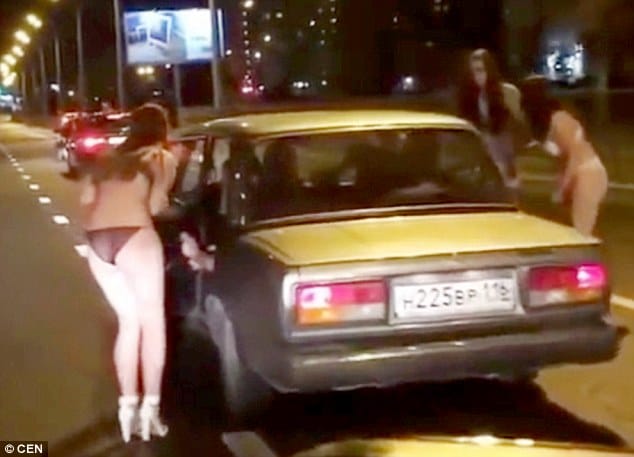 Russian women strips on road for clothes 