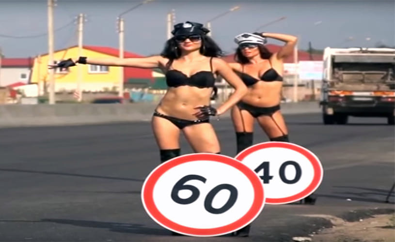 topless women to hold speed limit signs