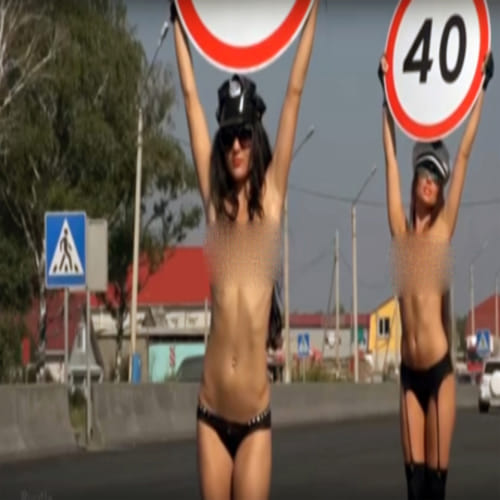topless women to hold speed limit signs