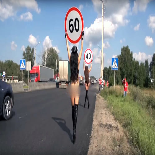 topless women to hold speed limit signs