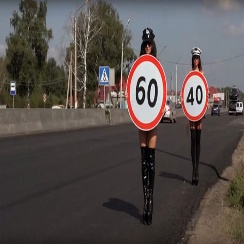 topless women to hold speed limit signs
