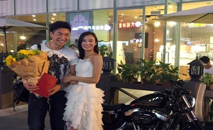 girl proposes to boyfriend with a Harley motorcycle and property deed