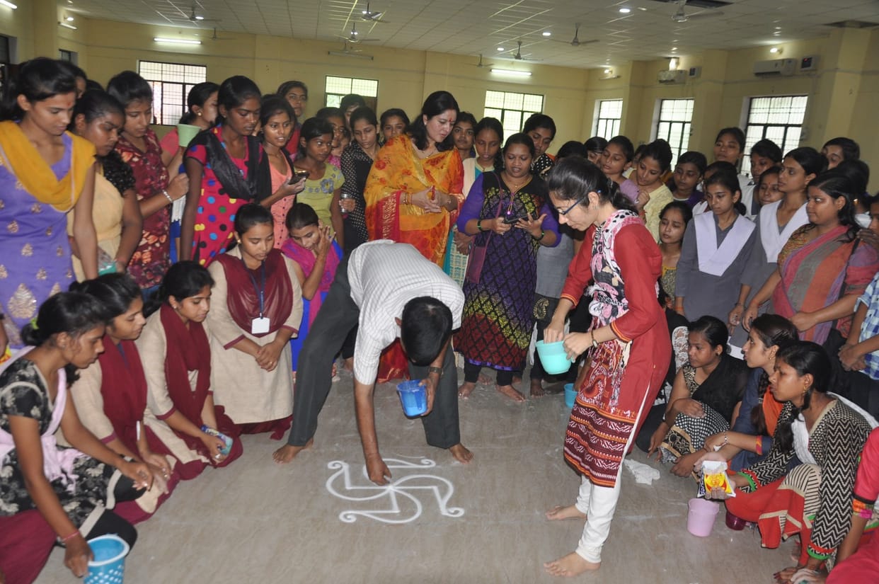 Girls learn how to make rangoli
