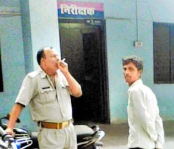 policeman smoking in police office