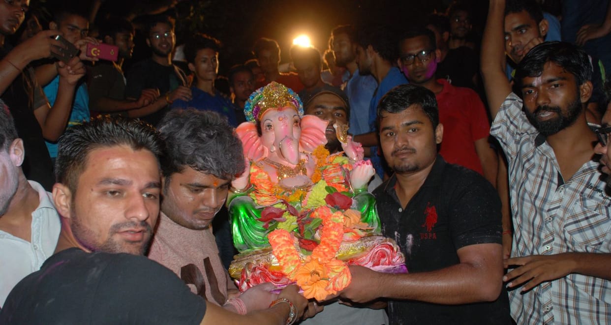 Ganesh idol immersed in water tank.