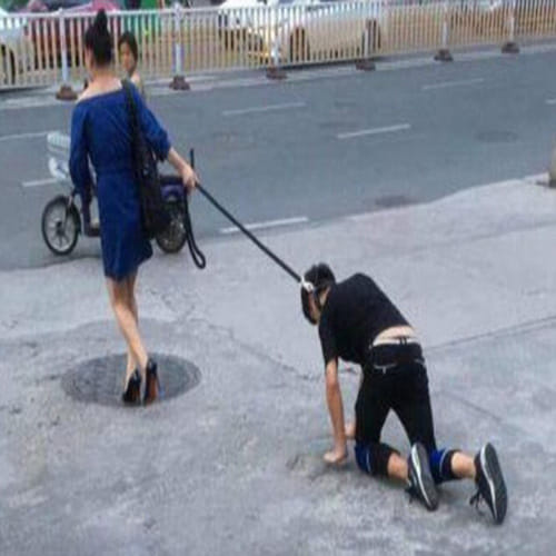 woman takes her boyfriend for a walk on a DOG LEASH 