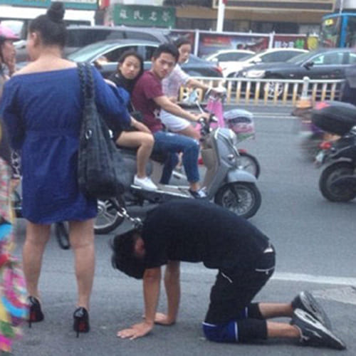 woman takes her boyfriend for a walk on a DOG LEASH 
