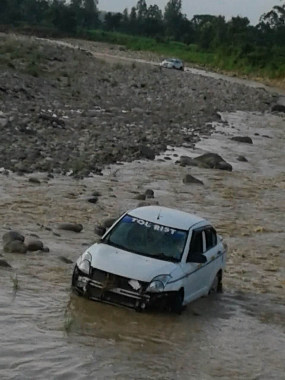 after heavy rain vehicle flows in flood
