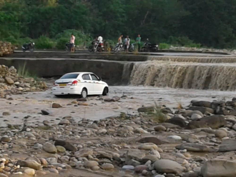 after heavy rain vehicle flows in flood