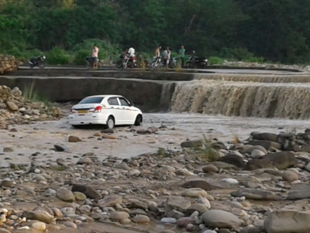 after heavy rain vehicle flows in flood