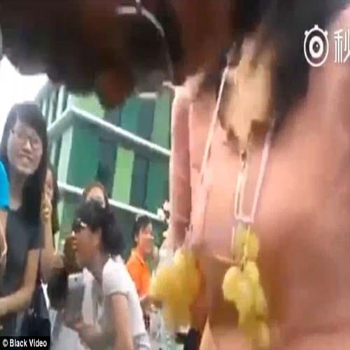 Male staff compete to eat grapes hung around female co-workers' BREASTS 