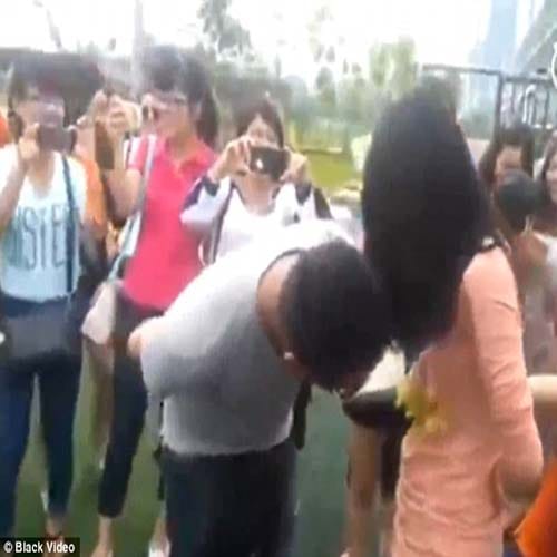 Male staff compete to eat grapes hung around female co-workers' BREASTS 