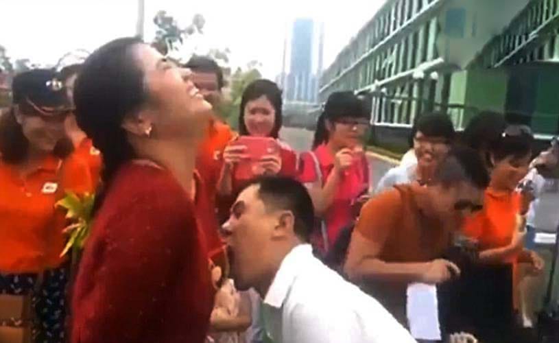 Male staff compete to eat grapes hung around female co-workers' BREASTS 
