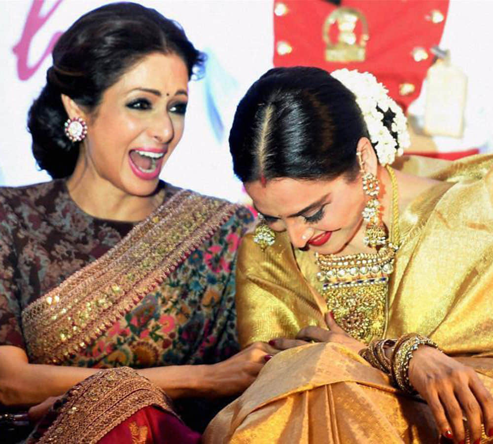 rekha spoted doing something inside her car