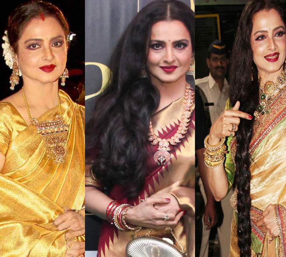 rekha spoted doing something inside her car