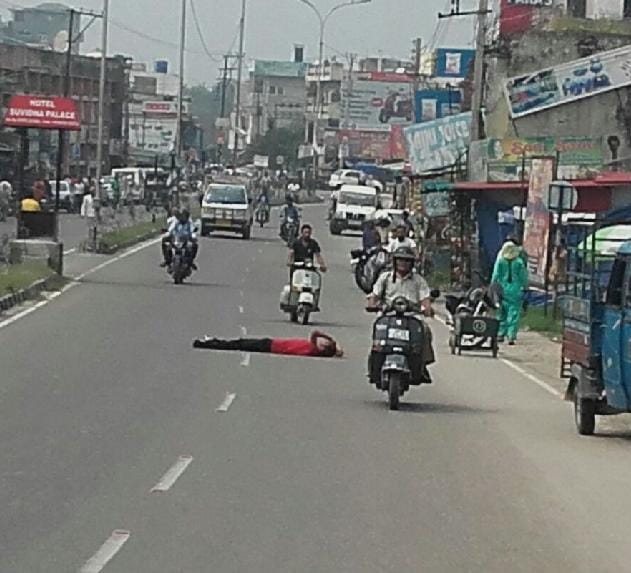 boy lay down on road