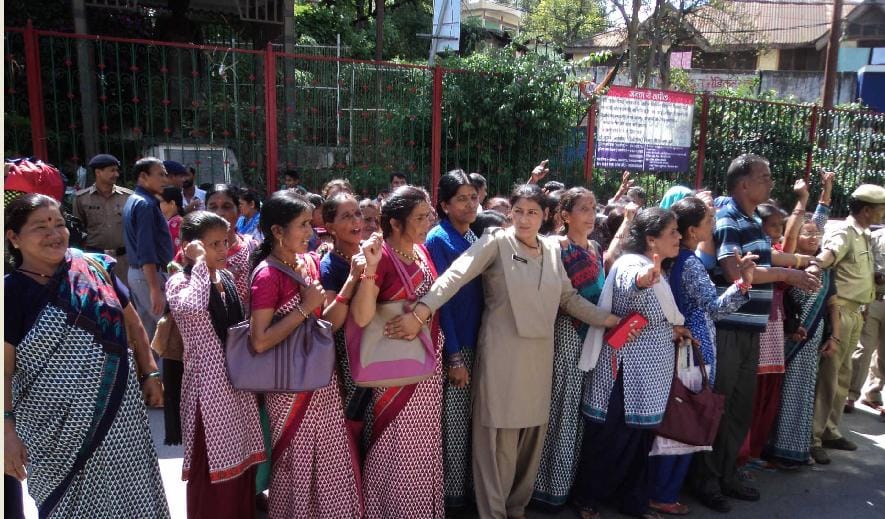 Anganwadi workers in developing building surrounded BDO