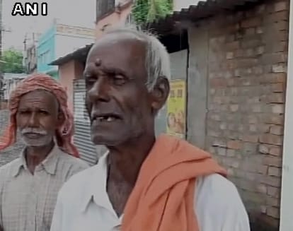 Three people carry dead body of relative in plastic bag