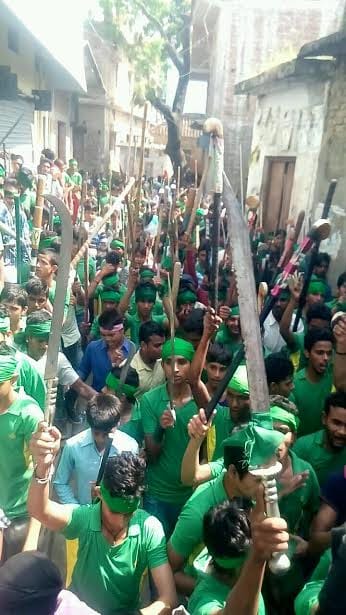 Guns and swords displayed in procession 
