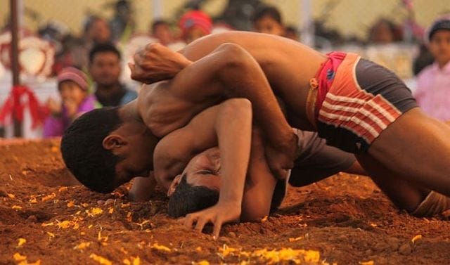 Wrestlers wrestling maneuvers shown